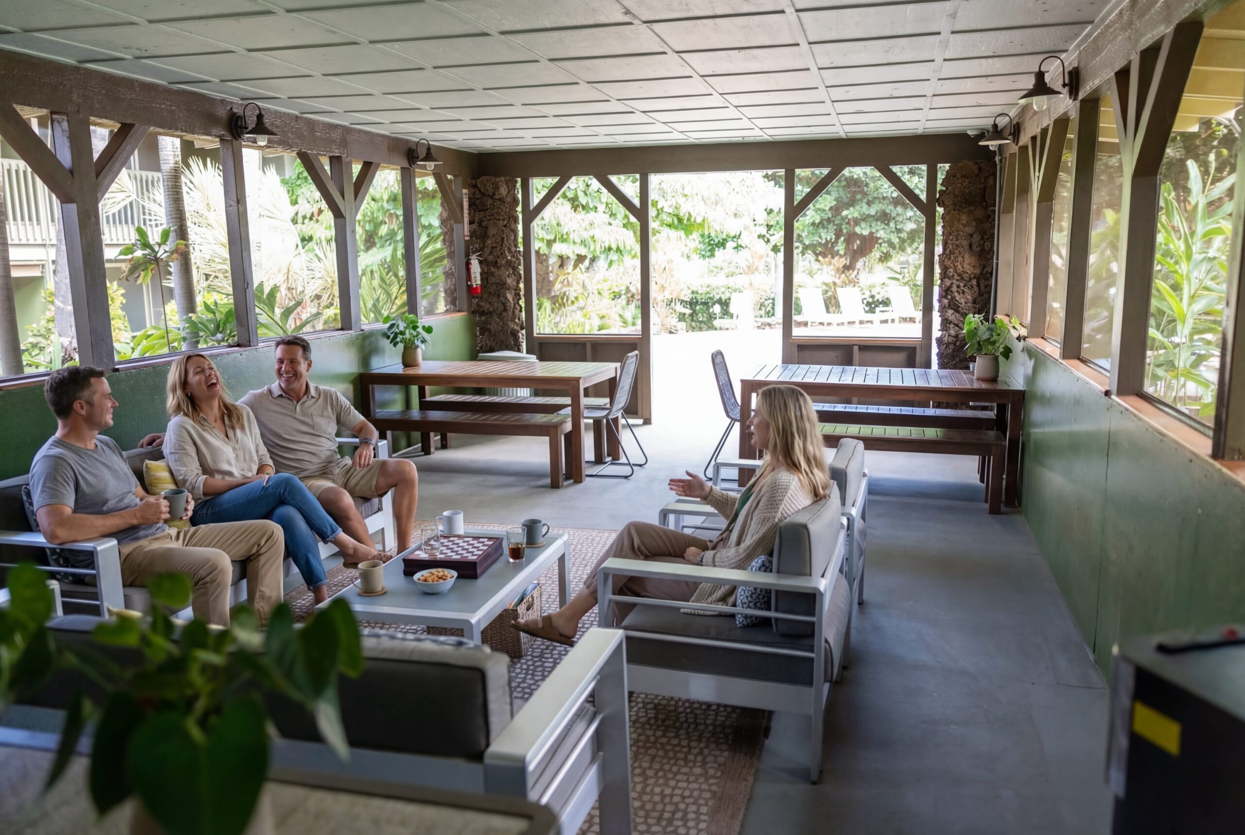 Napili Village Hotel, People relaxing in a covered outdoor lounge area, enjoying conversation and games.