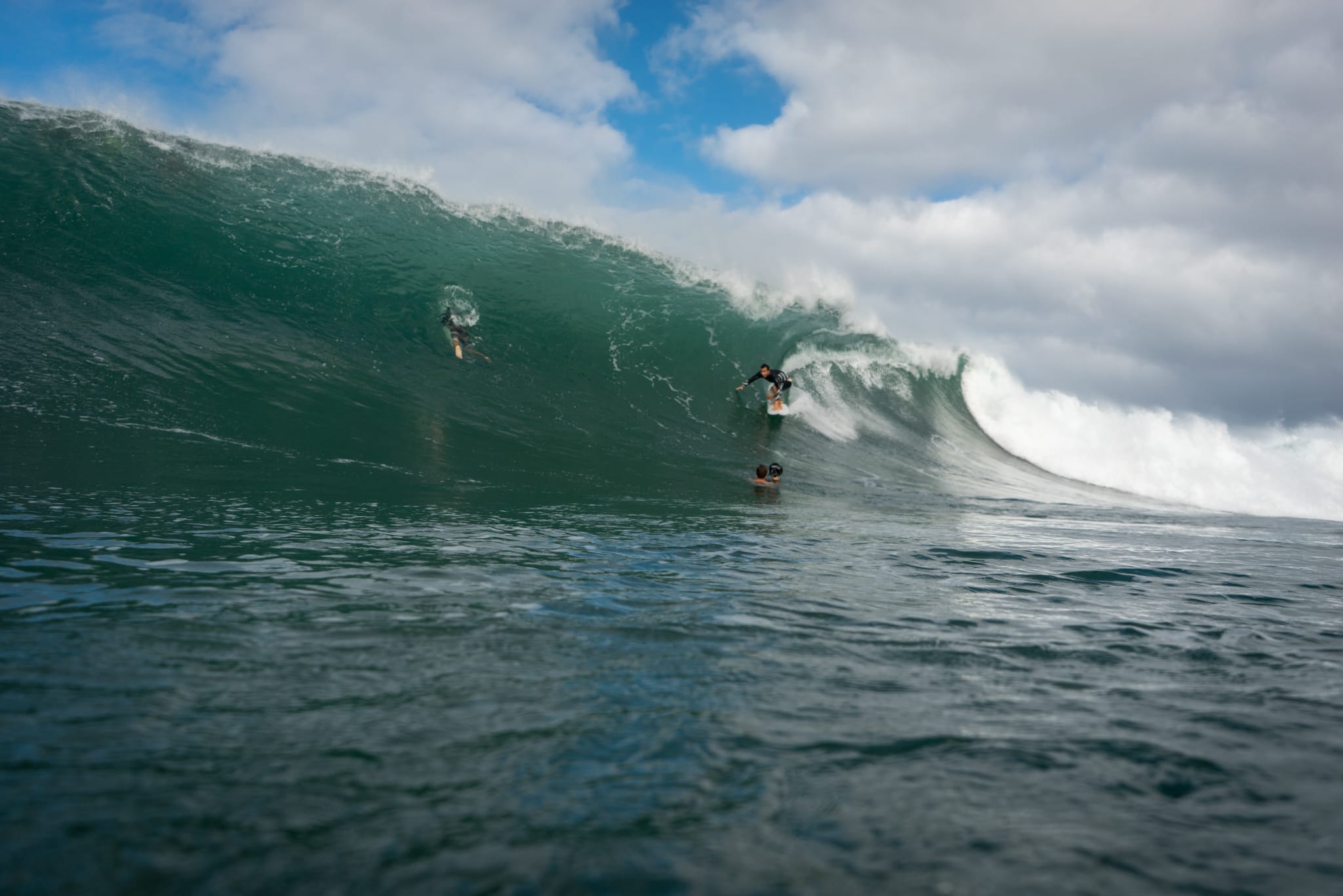 Napili Village Hotel, Surfer riding a massive wave at Honolua Bay, West Maui. Winter surf guide.